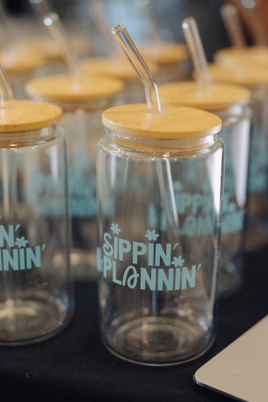 Clear tumblers with wooden lids and straws, featuring 'Sippin' Plannin' text.